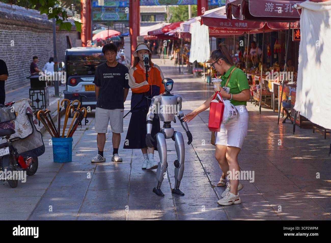 Humanoid robot interacting and walking through the streets of Qufu in China Stock Photo