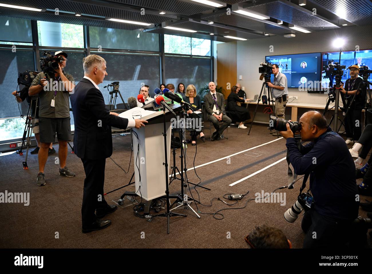 Optus Chief Executive Officer (CEO) Stephen Rue (left) speaks to the ...