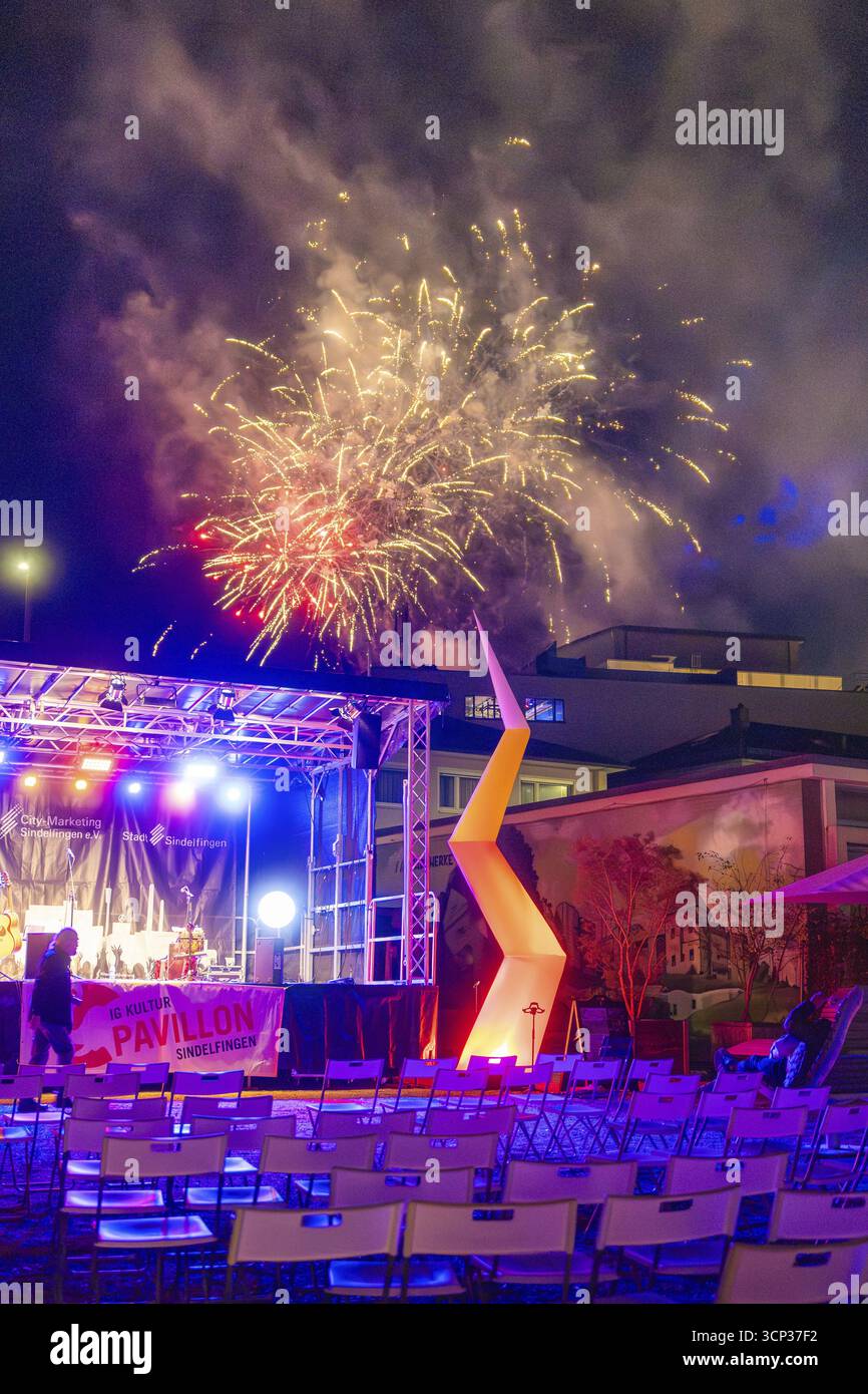 A colourful firework display over an illuminated stage at a night-time event, Fire Night, Sindelfingen, Germany Stock Photo