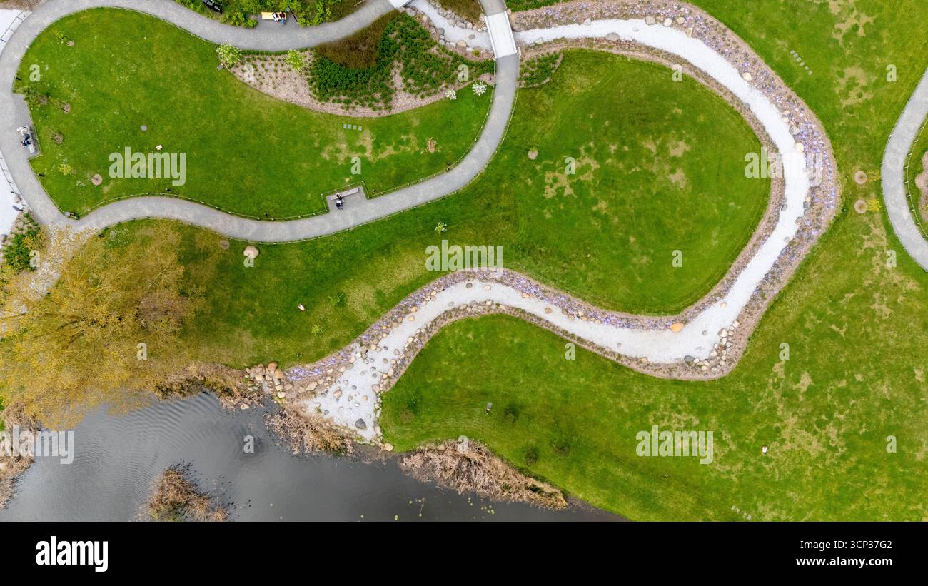Aerial view of a park with winding pathways and a pond Stock Photo - Alamy