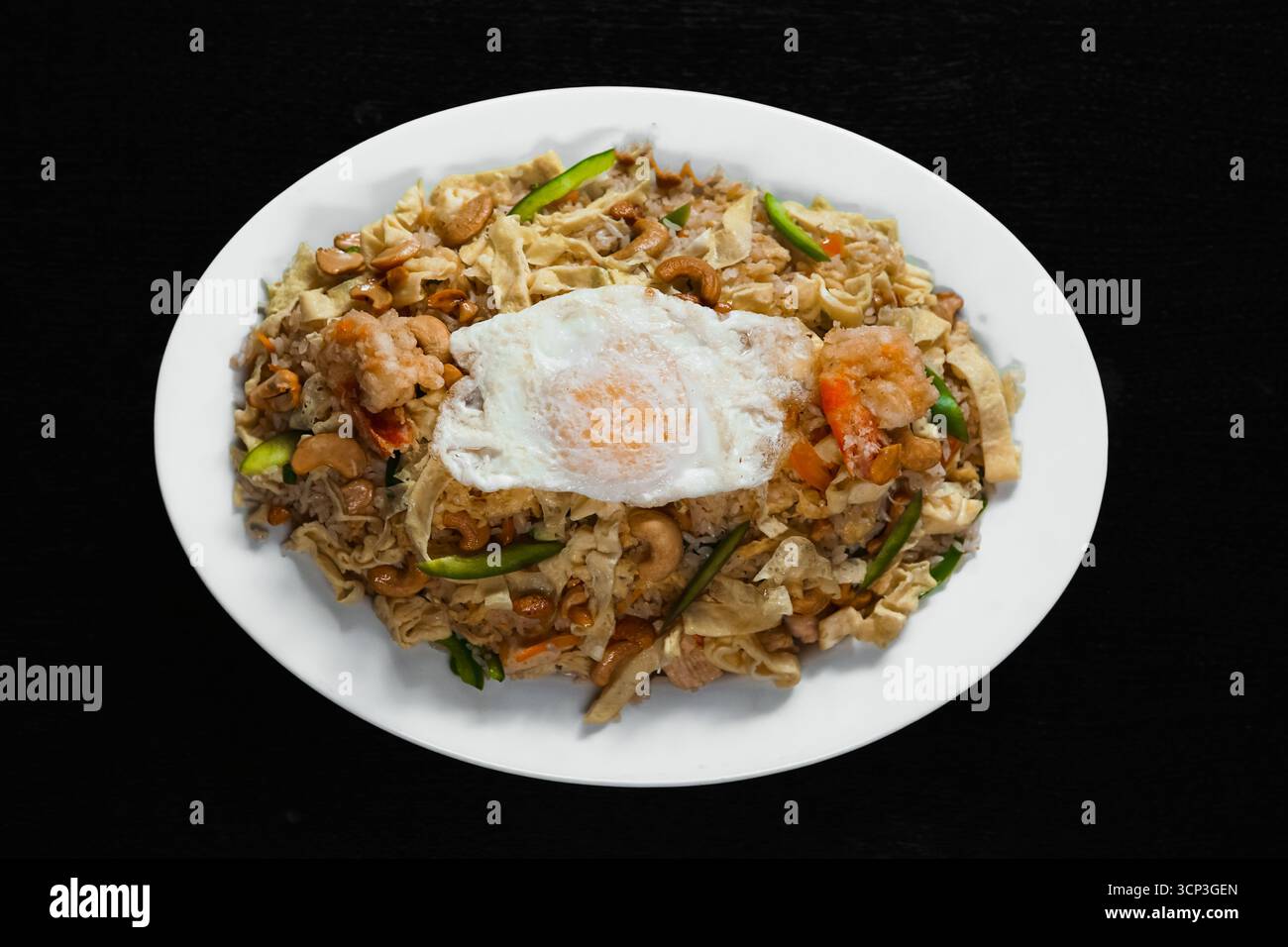 Special Mixed Fried Rice with Prawns, Chicken, Cashews, and a Sunny-Side Up Egg Stock Photo