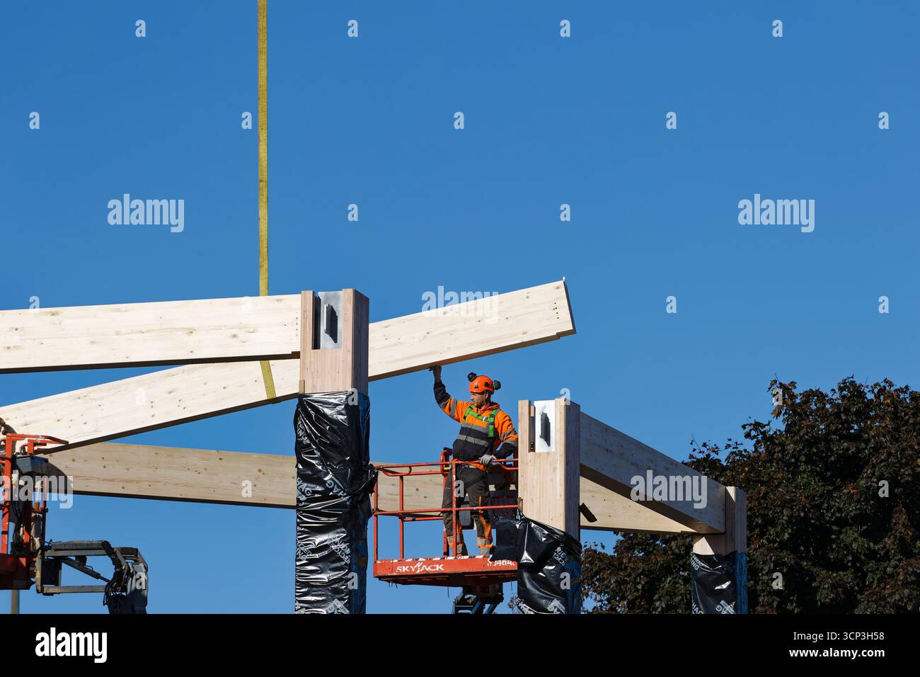 Workman Manchester Glulam laminated timber beam suspended from crane hi-res stock ...