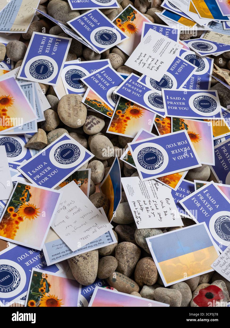 A collection of hand written prayer cards and inscribed pebbles inside the church of St Mary, Kersey, UK Stock Photo