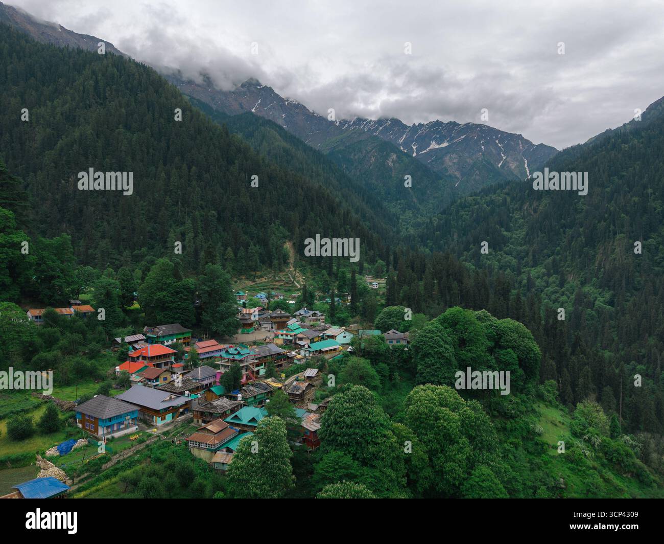 Aerial view of Grahan village nestled among lush green hills with snow ...