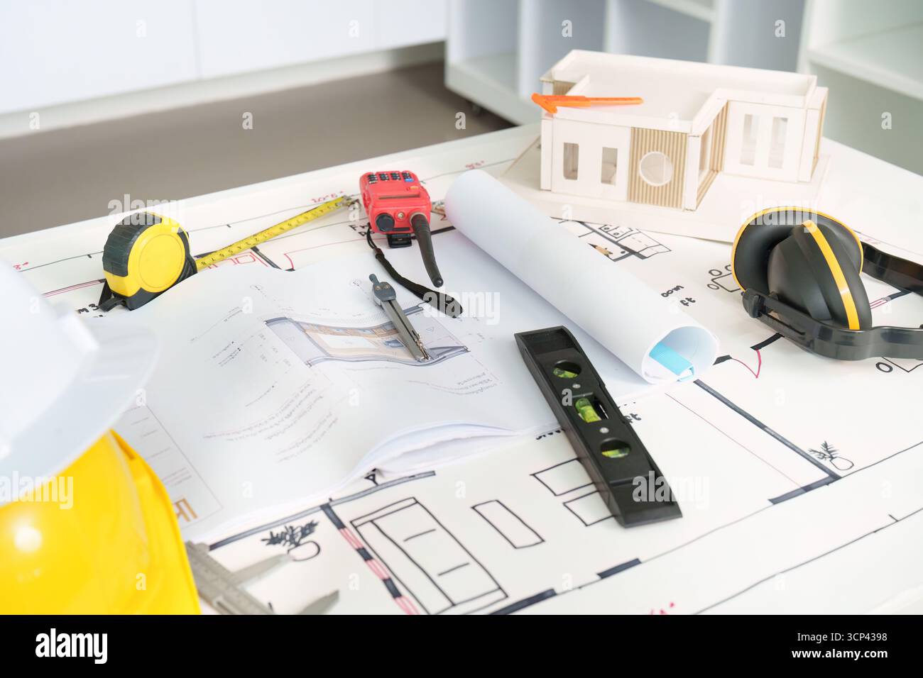 Engineering tools and plans for construction project on a table Stock Photo