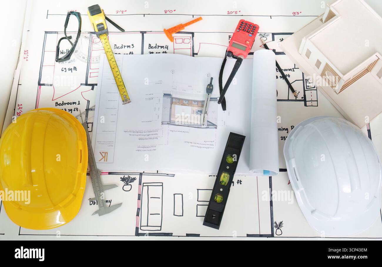 Construction plans and tools on a table for engineering project Stock Photo
