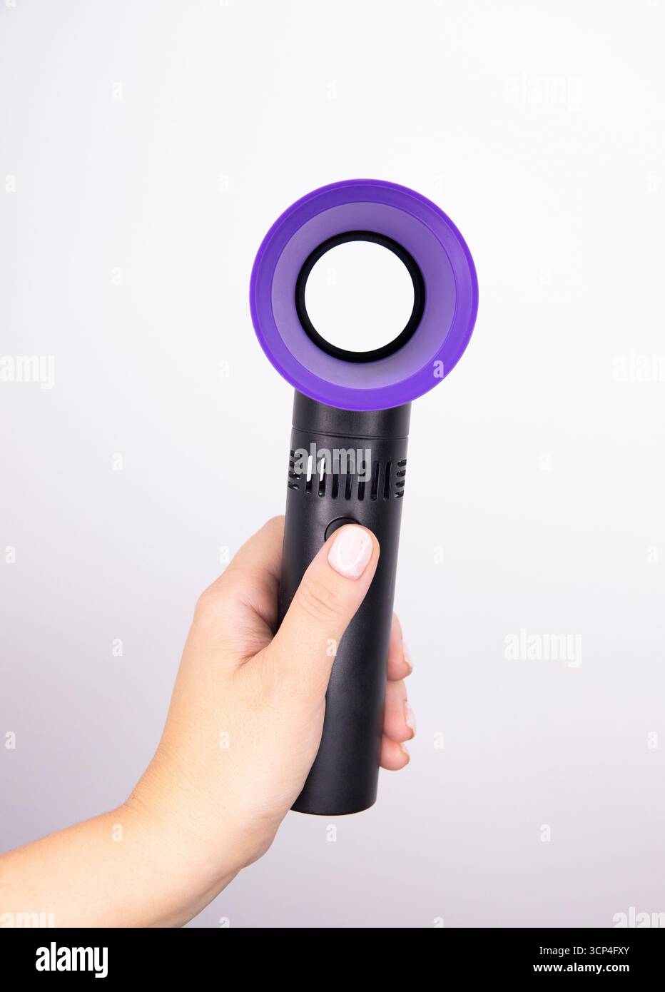 A handheld colorful fan on a white background. fan for makeup Stock Photo
