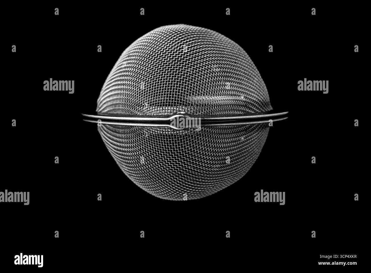 Small strainer texture on a black reflective surface Stock Photo
