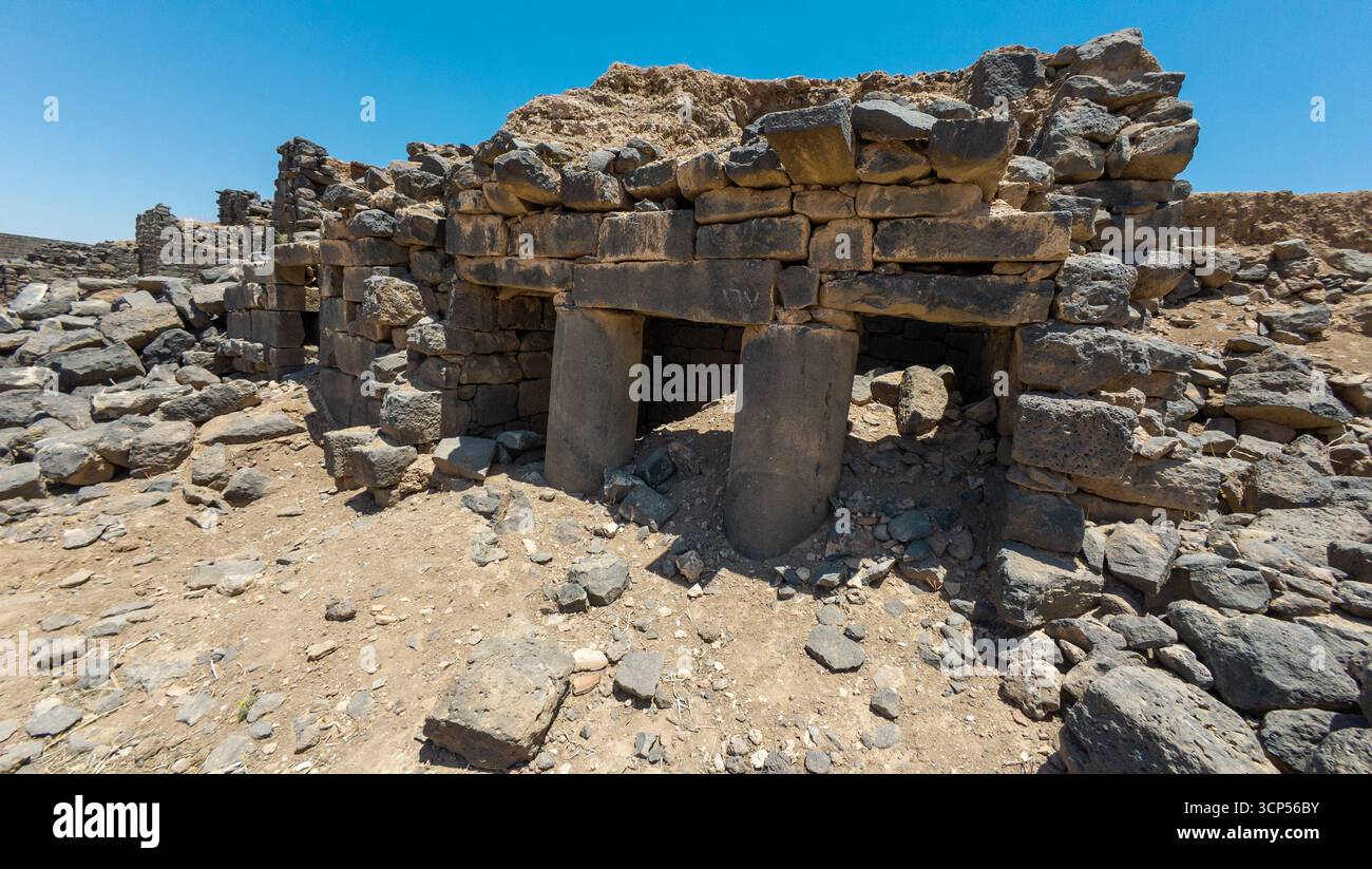 Shellstone Syria Ancient stone ruins with pillars under a clear blue sky. Ancient Dara ...