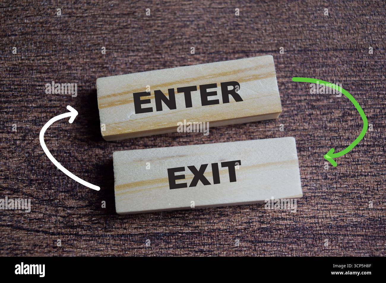 Enter and exit on stacked wooden cubes on the table. Symbolizing access and planning. Business and finance concept Stock Photo