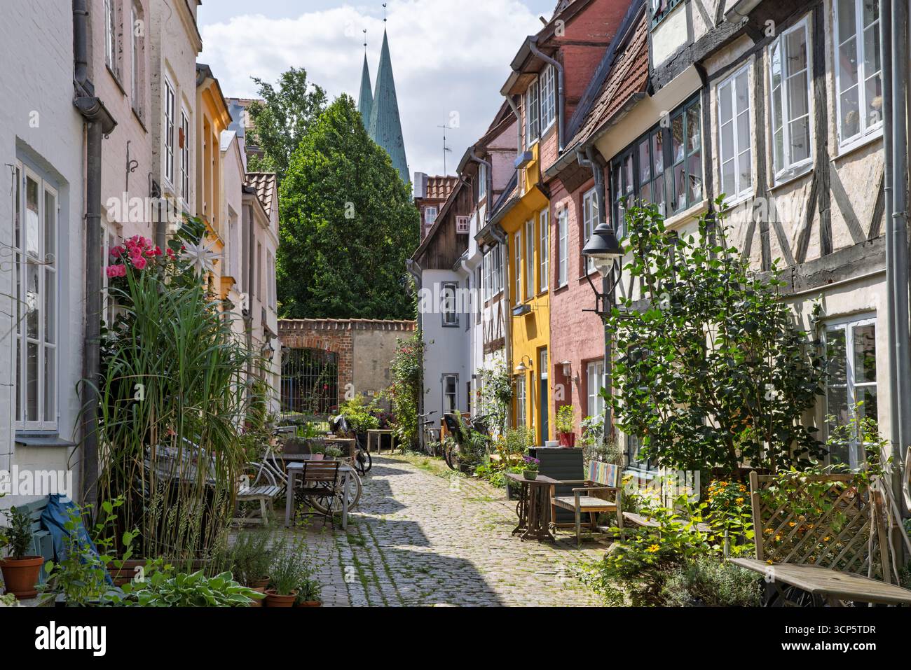 Colourful traditional houses in Sievers Thorweg overlooked by St Mary's church, Lubeck, Schleswig-Holstein, Germany, Europe Stock Photo