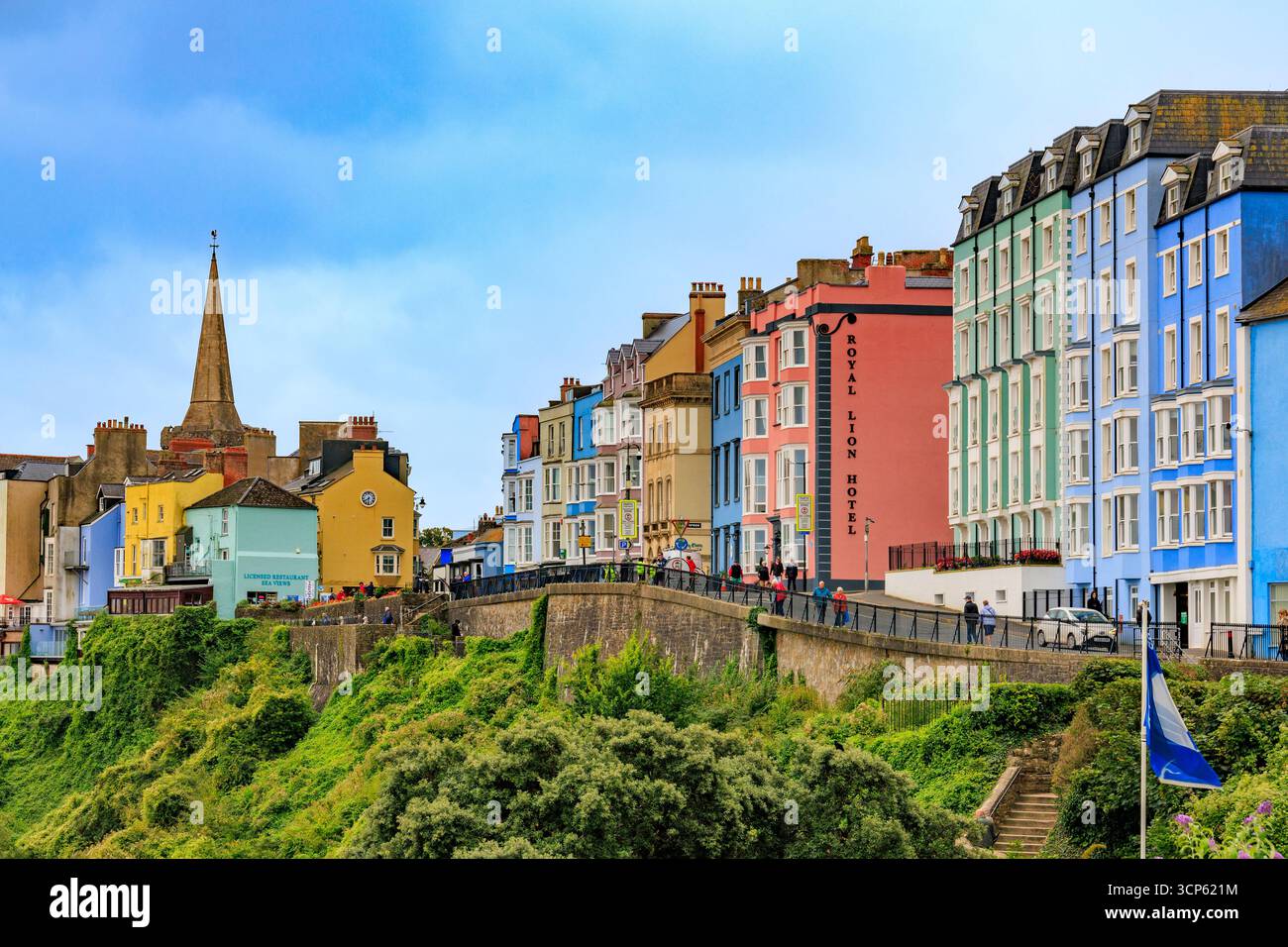 A row of multi coloured hotels line The Norton and overlook the harbour in Tenby, Pembrokeshire, South Wales, UK Stock Photo