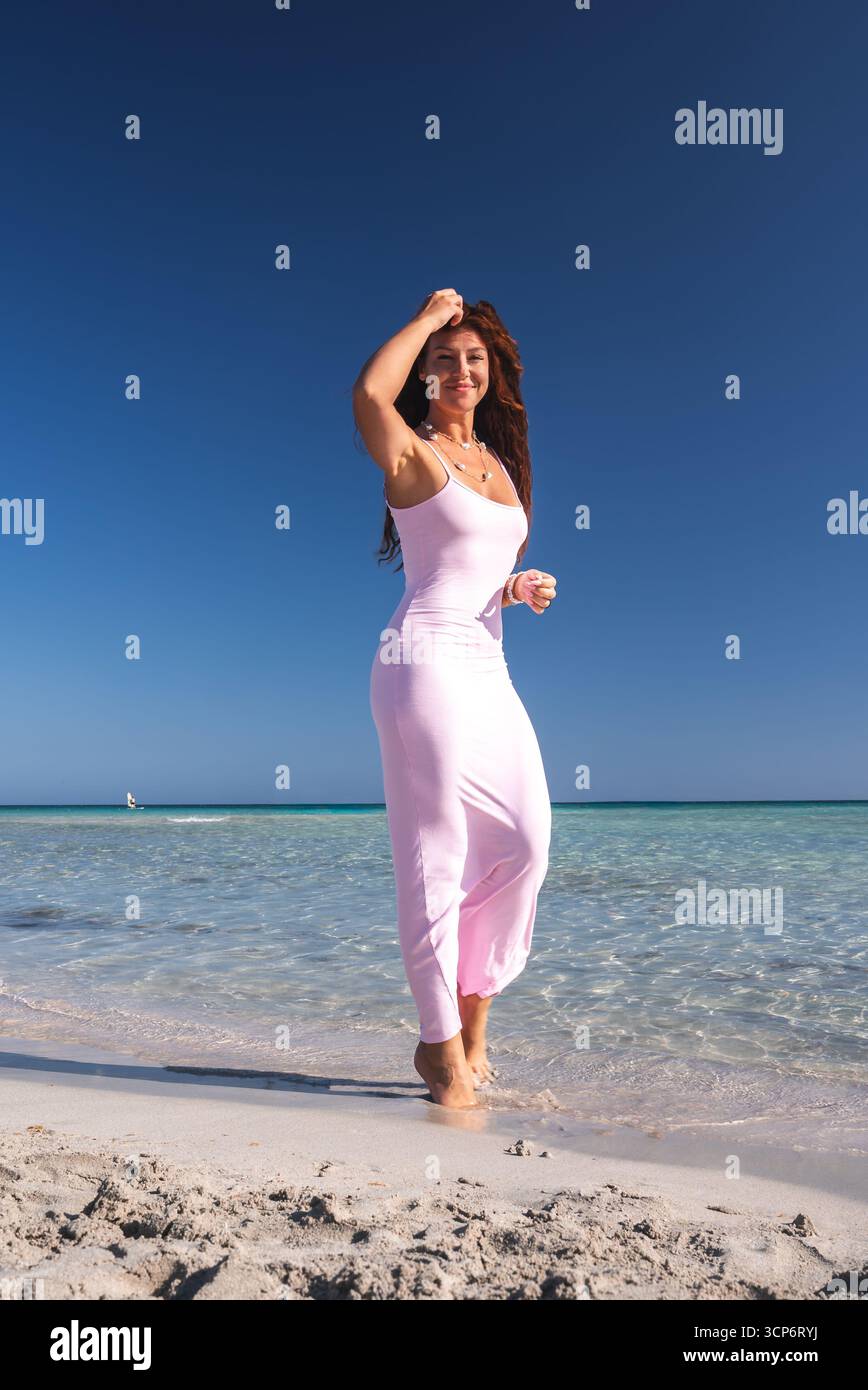 Woman in Pink Dress Walking on a Beach with Turquoise Water in Crete ...