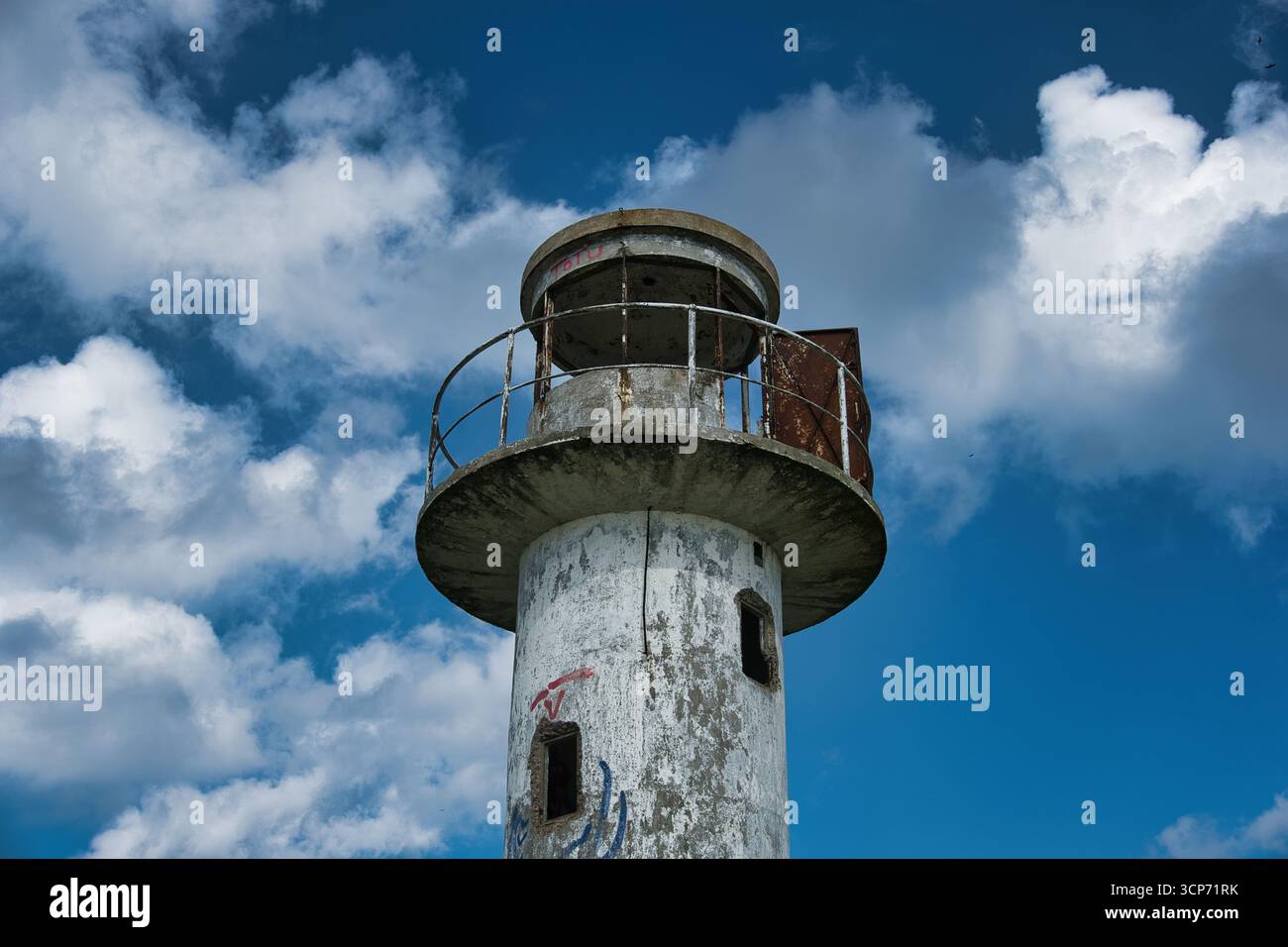 Old Weathered Lighthouse Against Blue Sky Stock Photo