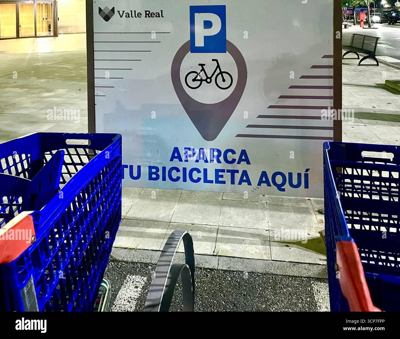 Shopping trolleys left in a bicycle parking bay with a sign park your bike here outside Carrefour hypermarket Valle Real Santander Cantabria Spain - Smartphone Captured Stock Image