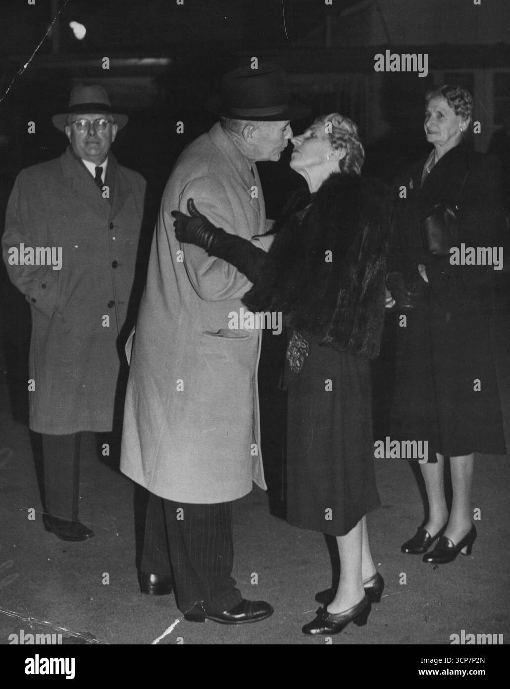 Ben Chifley- with wifeA farewell kiss for Mrs. Chifley before-planing at Kingsford Smith airport NSW, last year for a hurried official visit *****. August 30, 1950 Stock Photo