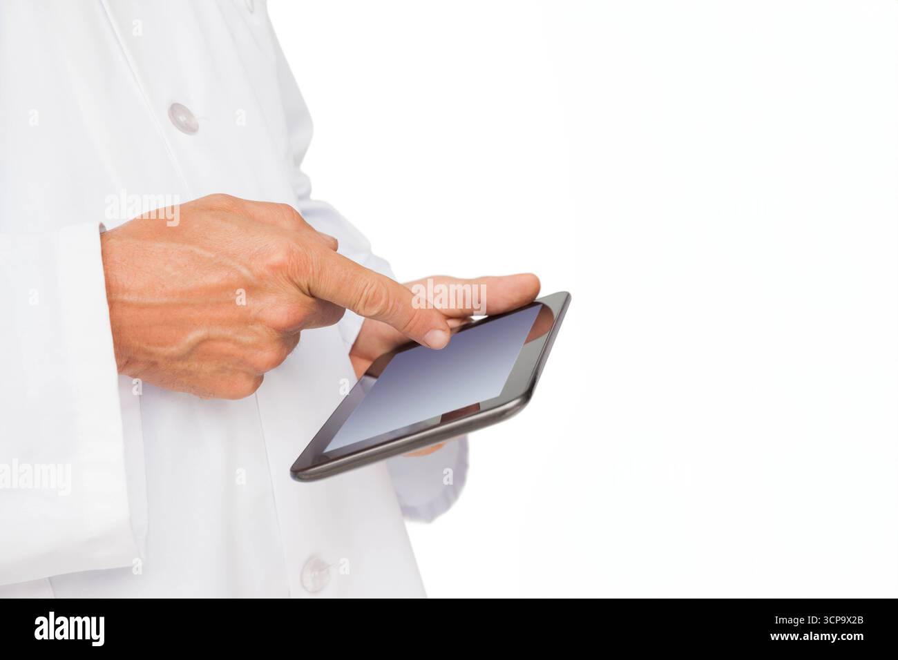 Hands wearing white lab coat tapping touchscreen tablet on plain white background, copy space Stock Photo