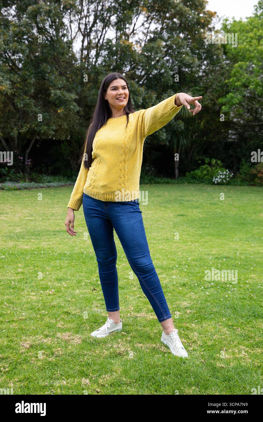 Woman in yellow sweater wearing hi-res stock photography and images - Alamy