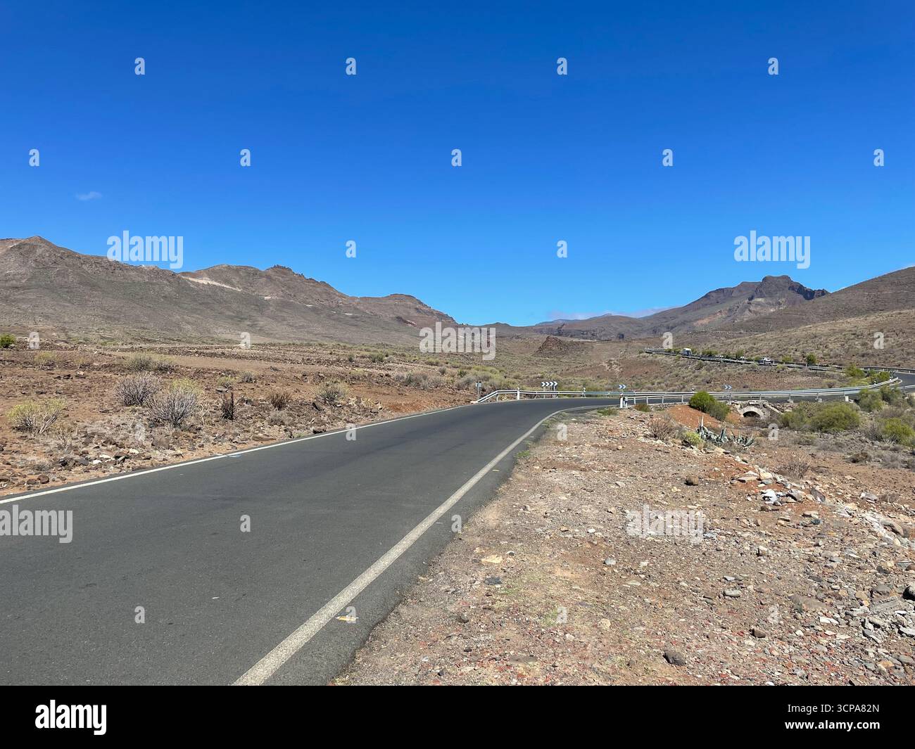Twisting mountain road with summer blue sky in Gran Canaria - Smartphone Captured Stock Image