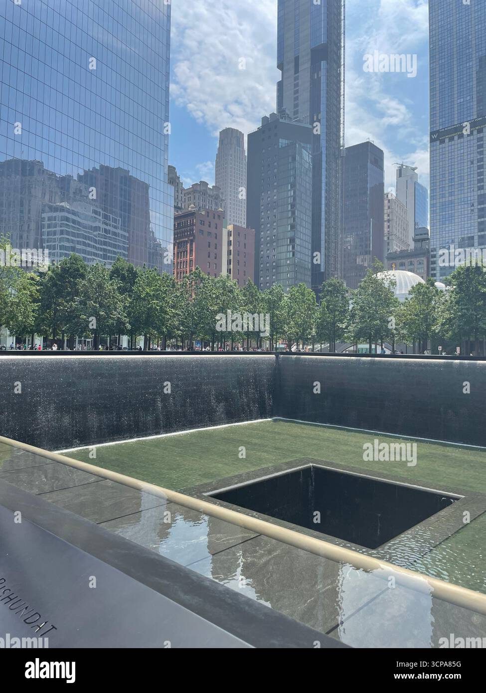 View of the twin towers memorial with the financial district tower blocks behind - Smartphone Captured Stock Image