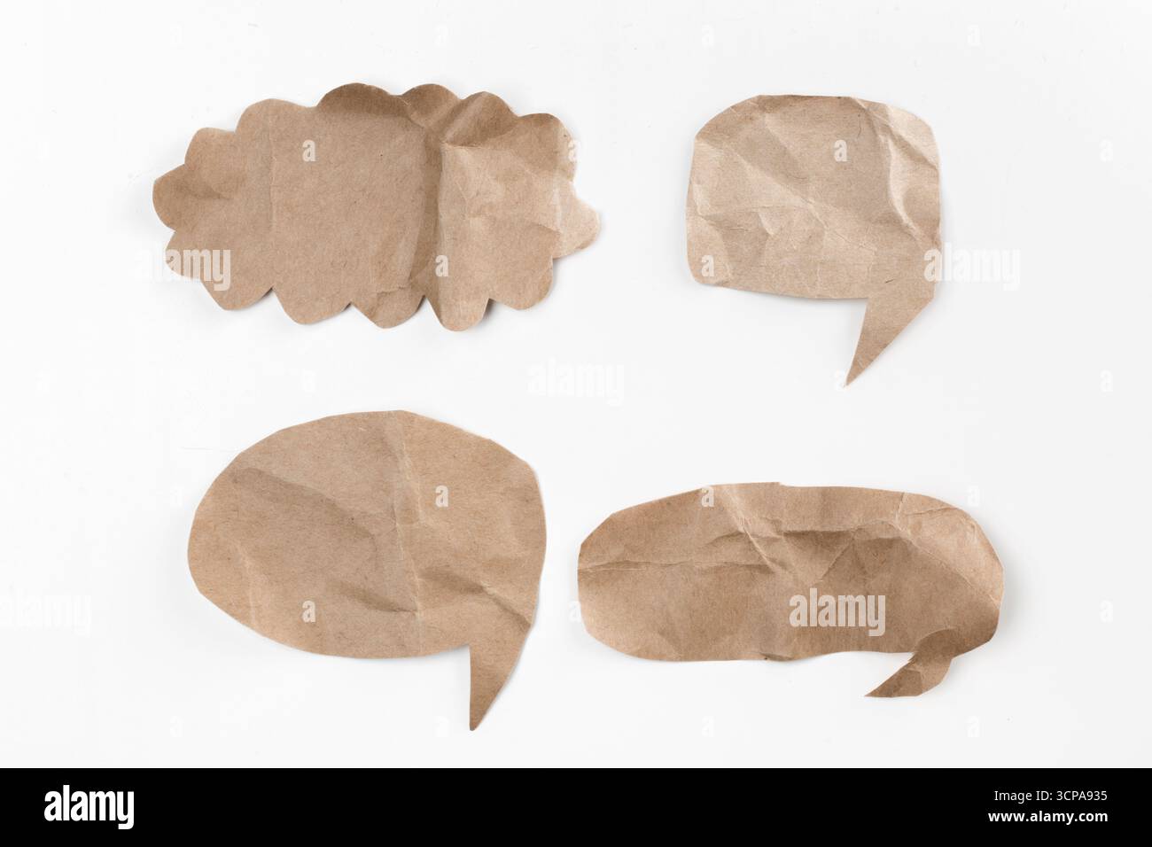Creative paper speech bubbles arranged on a white background for communication concepts Stock Photo