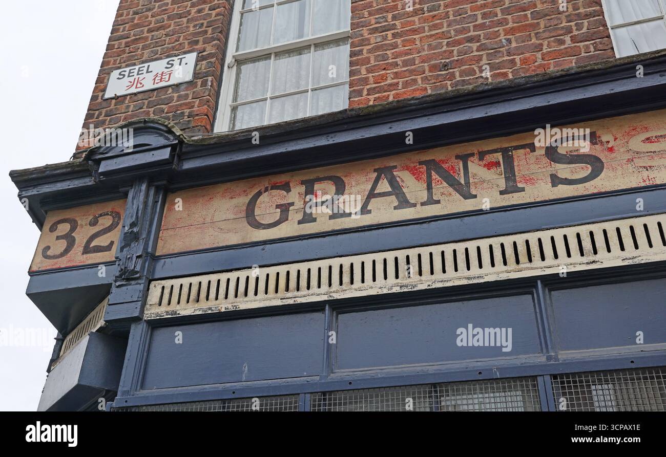Faded historic shopfront signage reading “Grants” on a former retail premises at 32 Seel Street, in the Chinatown area of Liverpool city Merseyside Stock Photo