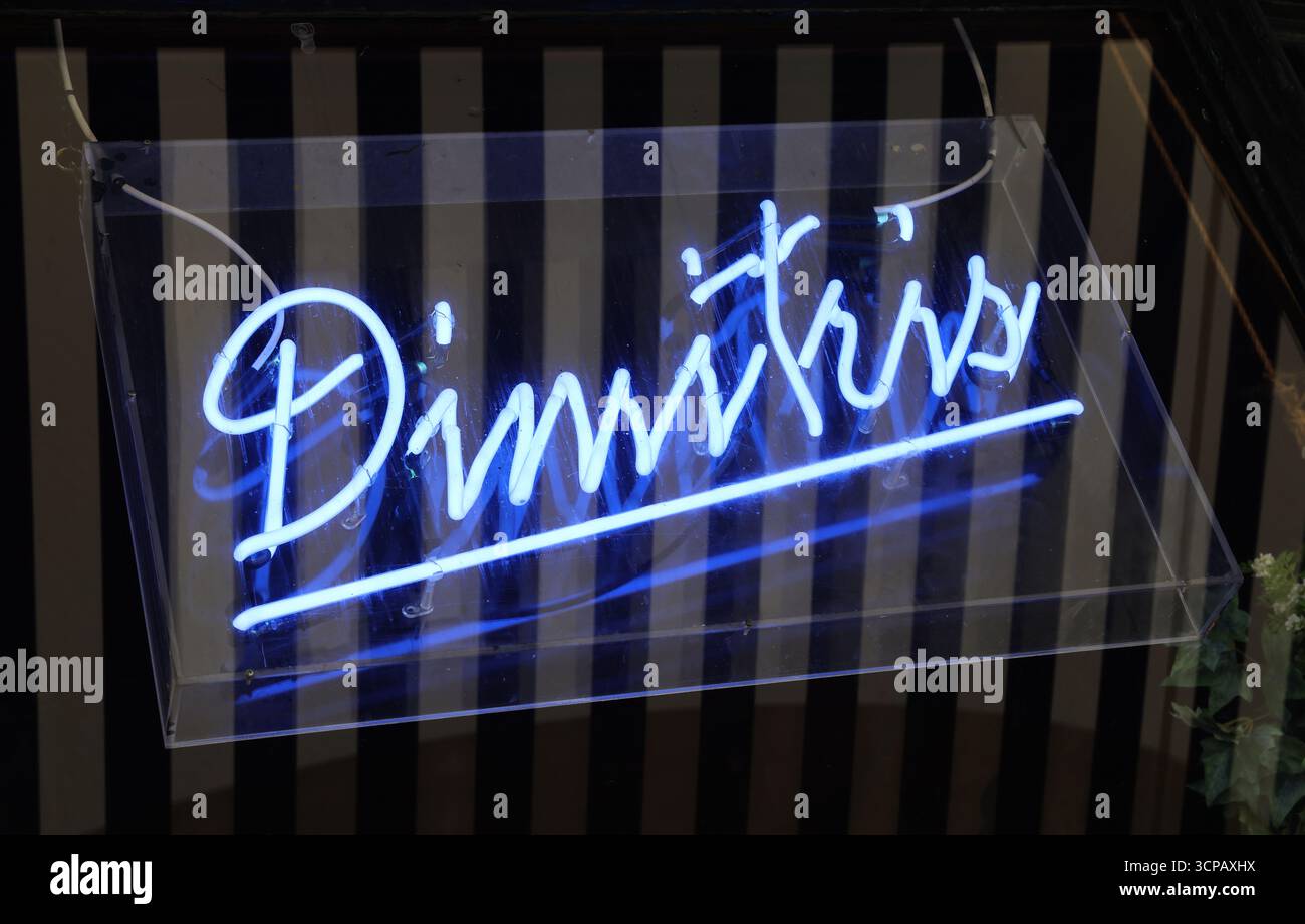 Blue neon sign for Dimitri’s Greek restaurant inside Campfield Arcade Deansgate, a long-established independent dining venue in Manchester city centre Stock Photo