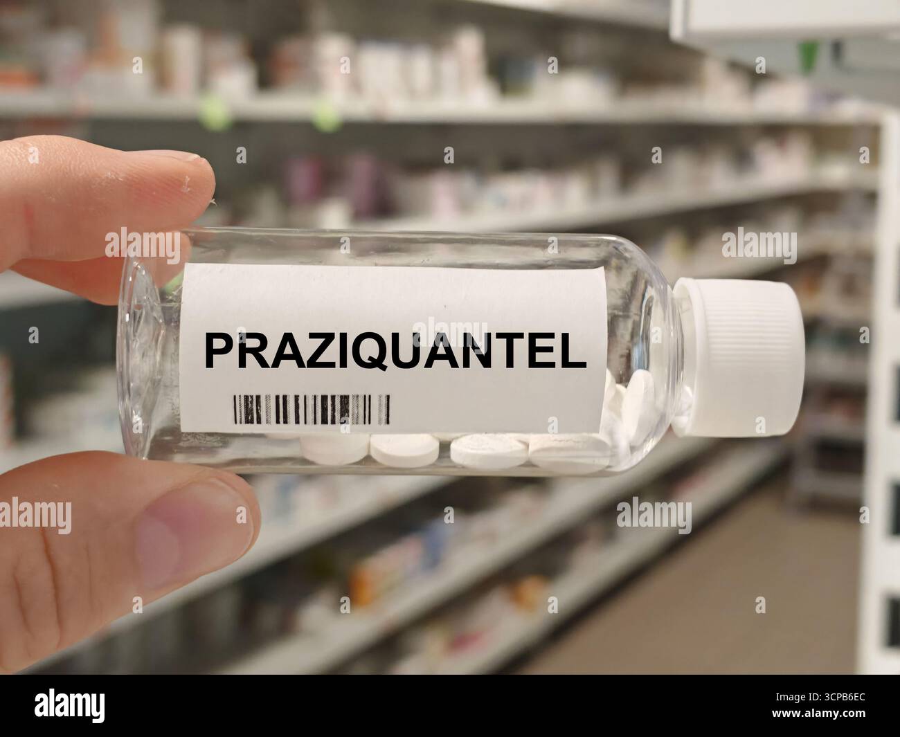 Box of PRAZIQUANTEL tablets on a hospital pharmacy table used to treat parasitic worm infections an anthelmintic. Stock Photo