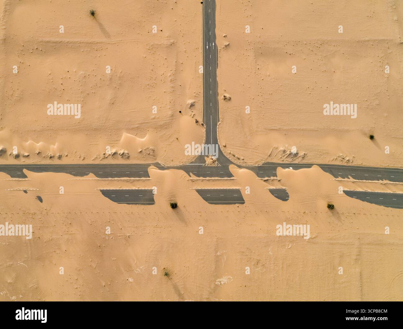 Aerial view of roads cutting through the undulating desert landscape ...