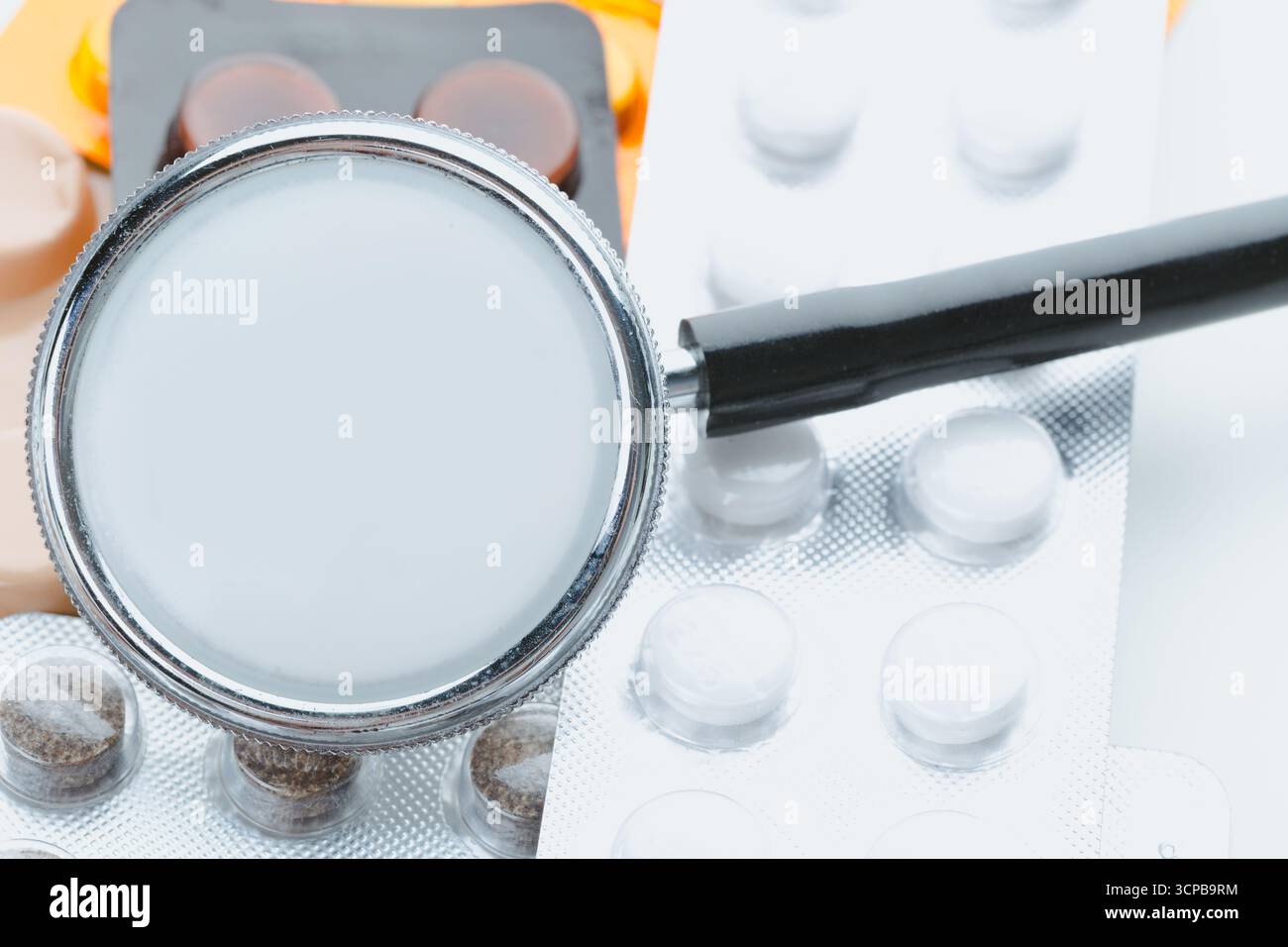 Medical tools and medications arranged on a workspace in a bright setting Stock Photo
