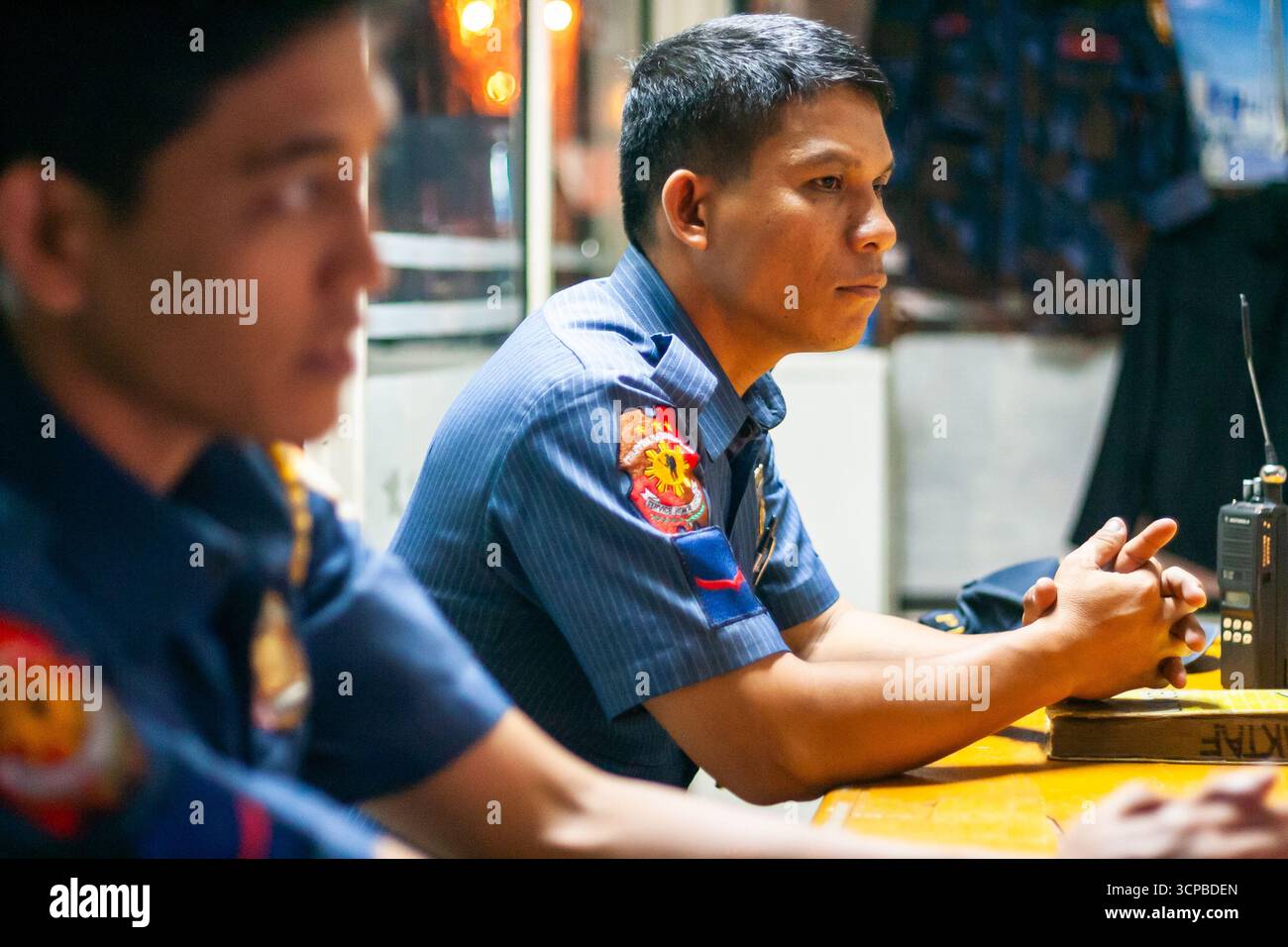 Two Philippine police officers at a police station in Quezon City, Philippines Stock Photo