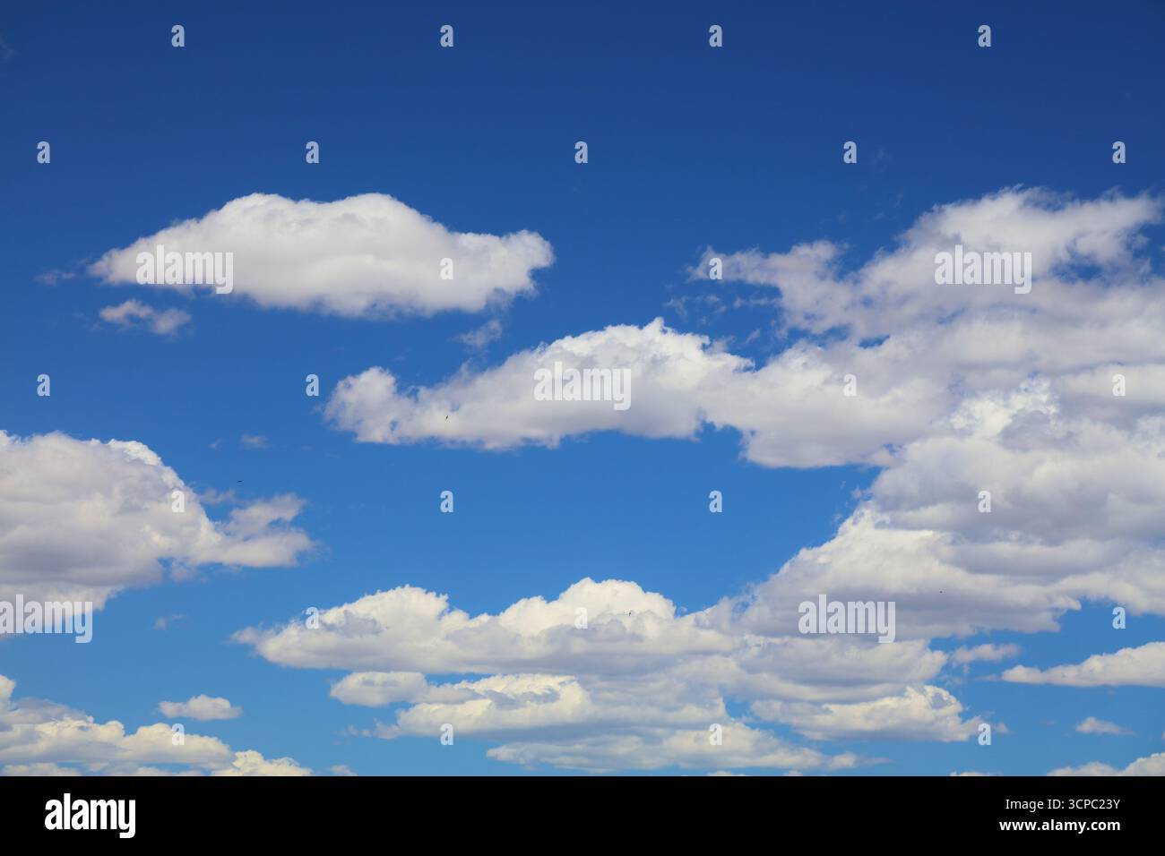 White clouds blue sky background. White fluffly clouds texture. Stock Photo