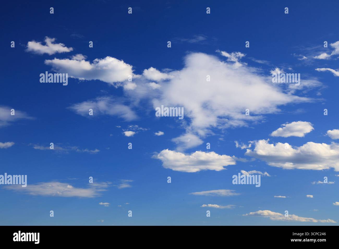 White clouds blue sky background. White fluffly clouds texture. Stock Photo