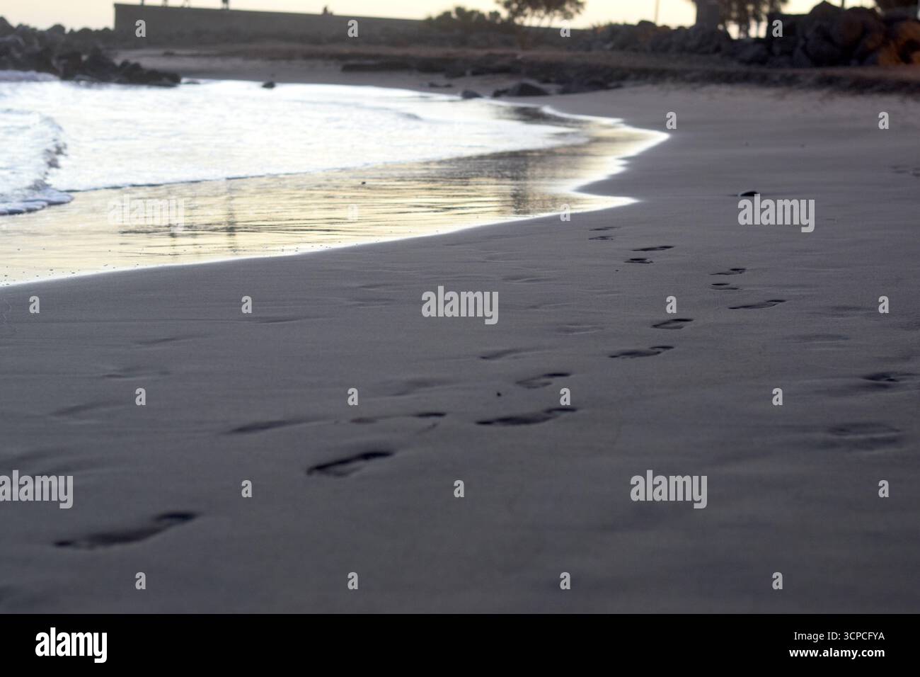 footsteps at the beach in evening Stock Photo