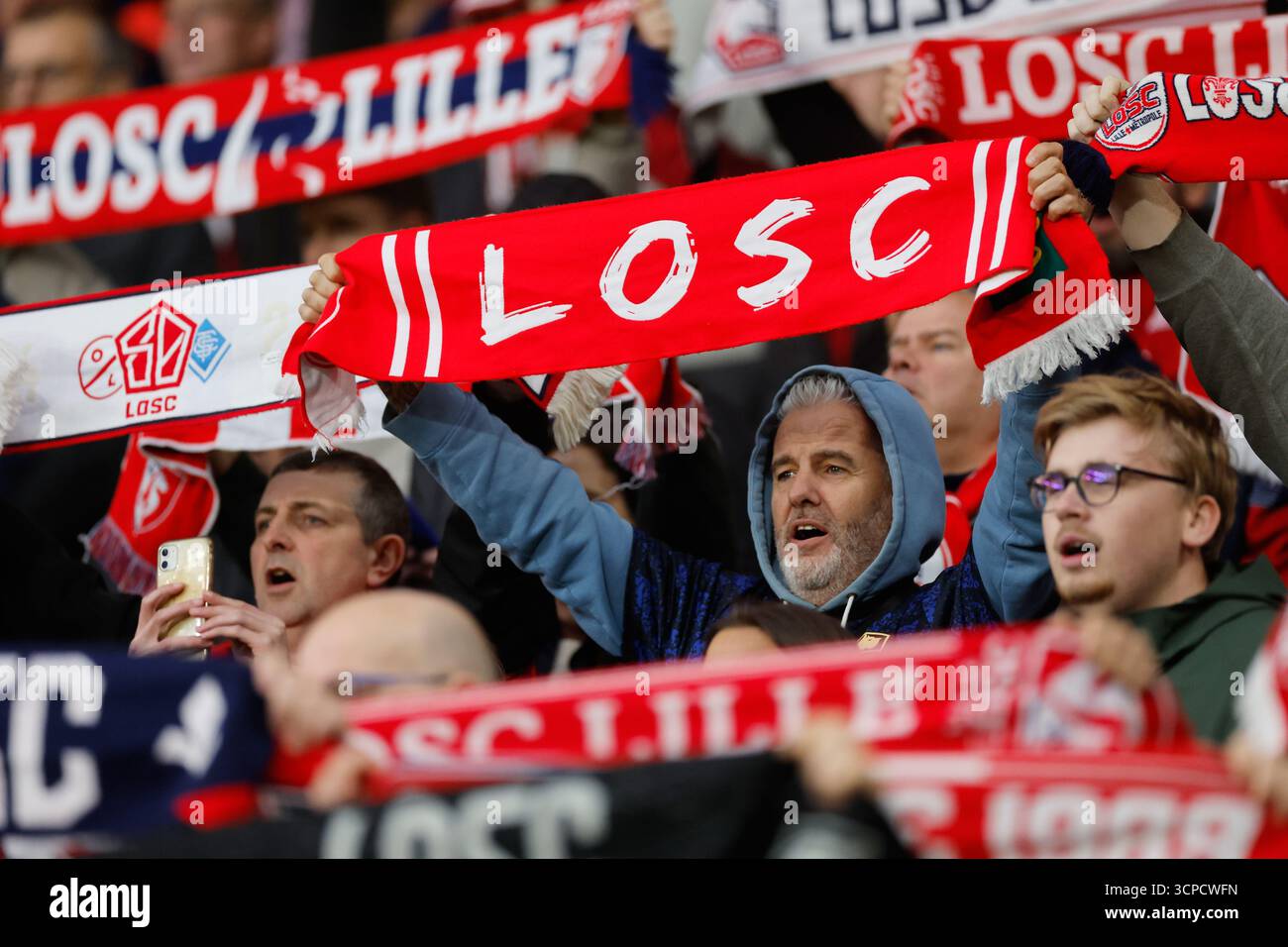 Fans hold scarves and cheer for Lille prior to the Europa League soccer ...