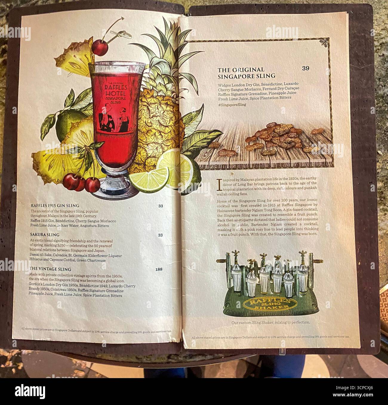 The Raffles Long bar list shows two other added cocktails besides the well-known Singapore Sling, are the Sakura Sling and the Vintage Sling served in - Smartphone Captured Stock Image