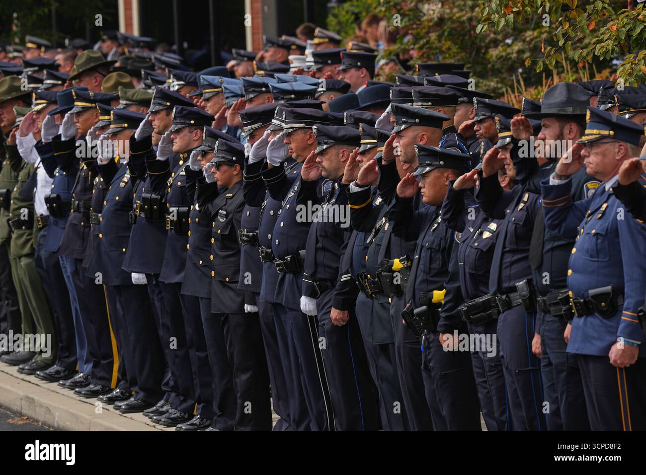 Officers salute at the conclusion of funeral services for slain ...
