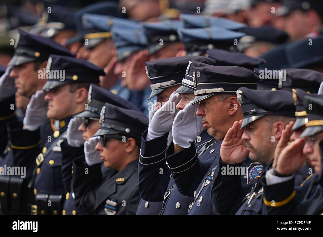 Officers salute at the conclusion of funeral services for slain ...