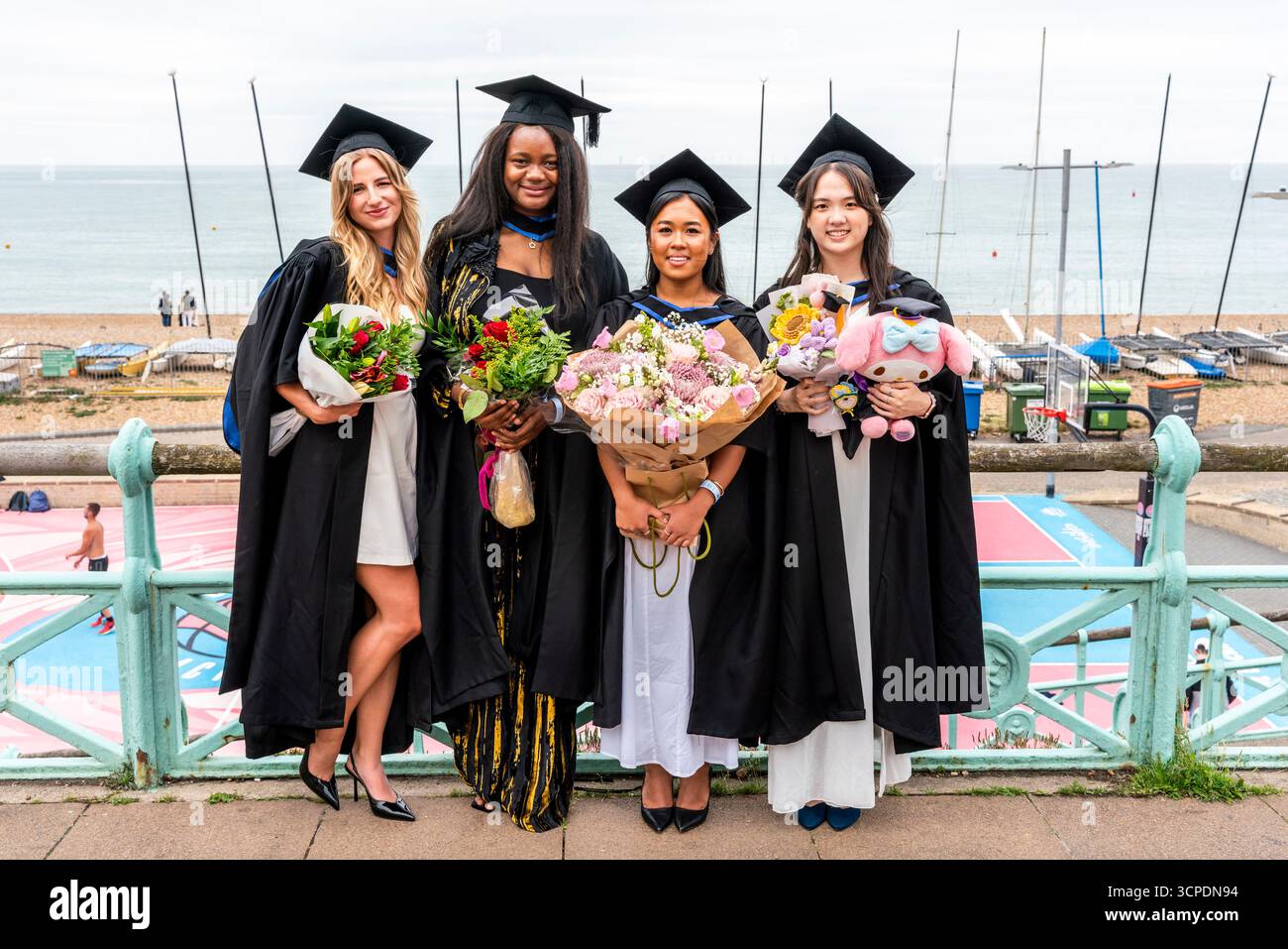University of Brighton Students Poses For A Photo On The Seafront After ...