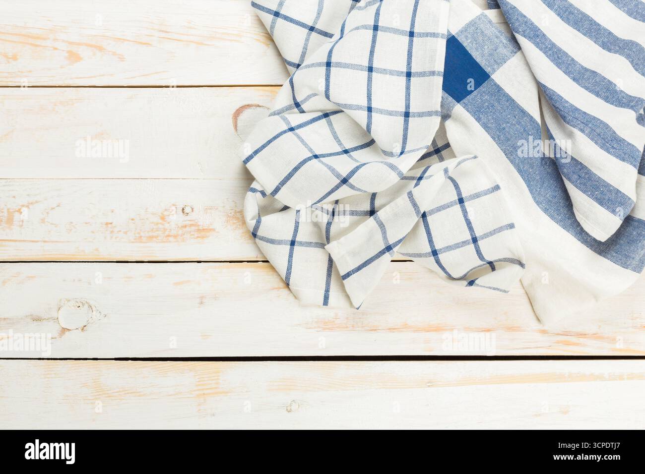 Soft linen fabrics with checked patterns on a rustic wood surface Stock Photo