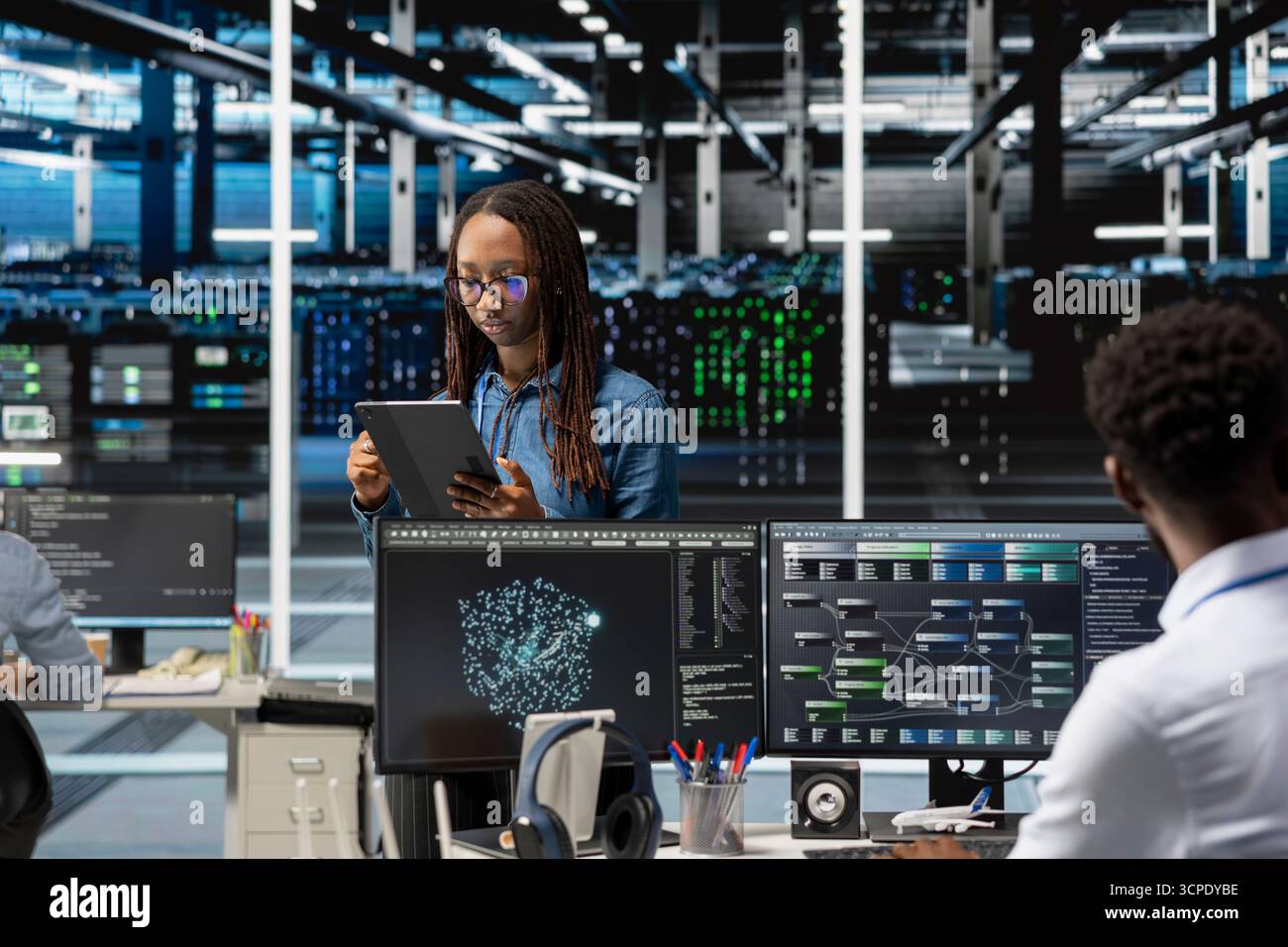 Data center computer scientist uses AI visualization program to oversee automated repetitive tasks. Woman in server hub modifying infrastructure rigs systems based on data analytics graphs Stock Photo