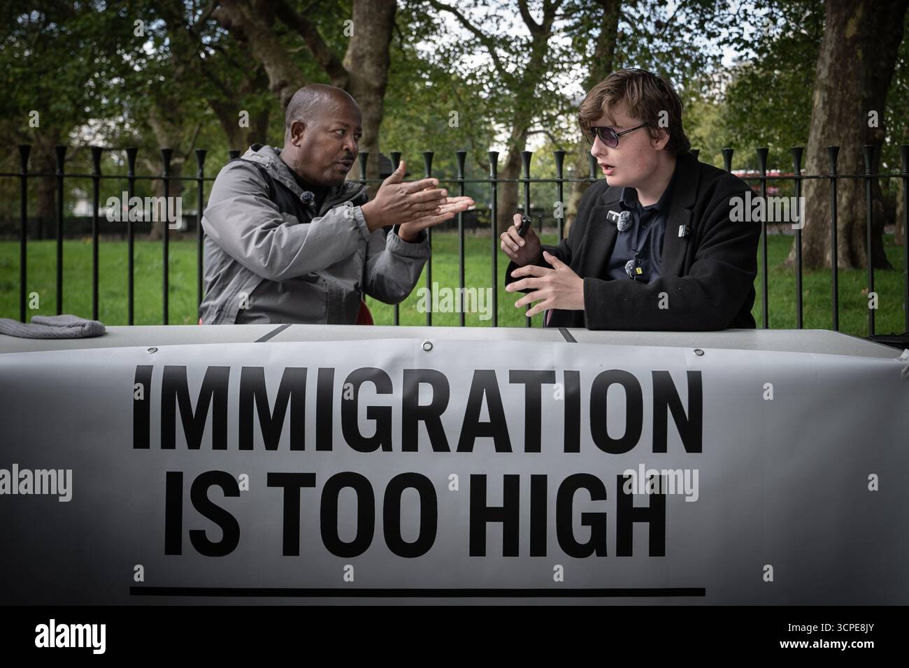 ‘Immigration is Too High’ debate between a working UK based migrant(L) and anti-immigration activist Young Bob(R) at Speakers’ Corner, London, UK Stock Photo