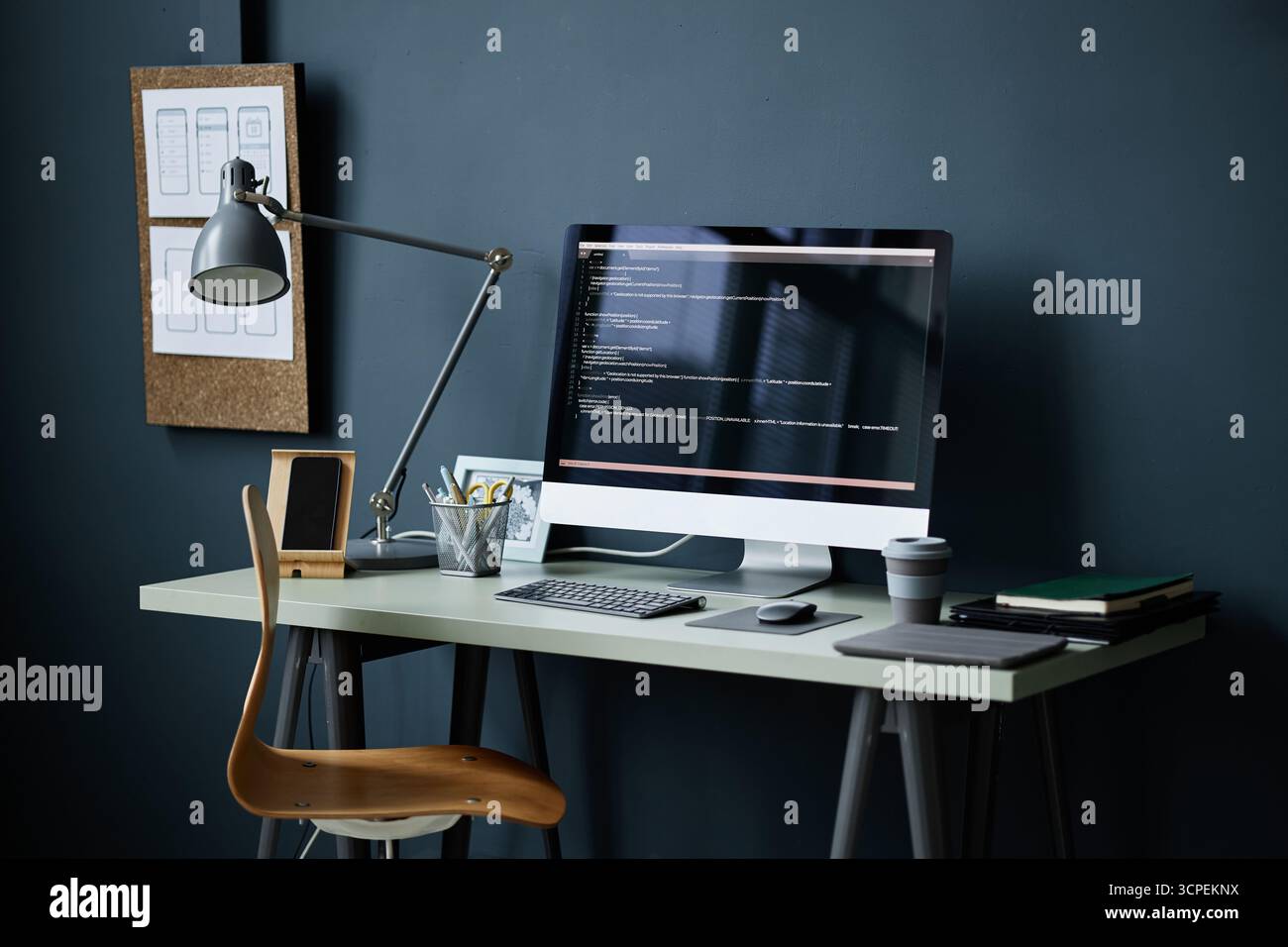Modern Workspace Featuring Computer Monitor Displaying Programming Code Stock Photo
