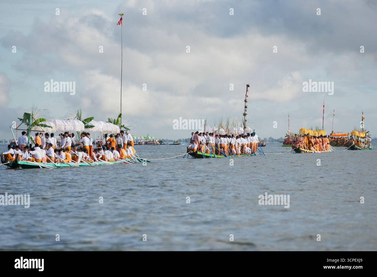 Intha ethnic people wait on a long boat in a procession carrying Buddha ...