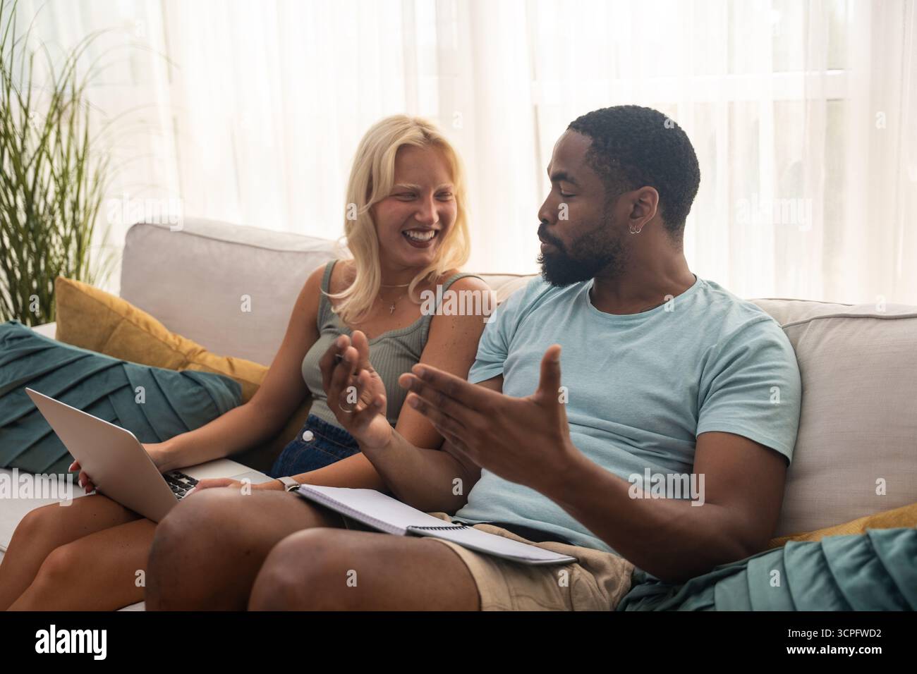 Young couple, freelancer businessman and businesswoman, working at home on laptop computer, testing new innovative technology and online internet tool Stock Photo