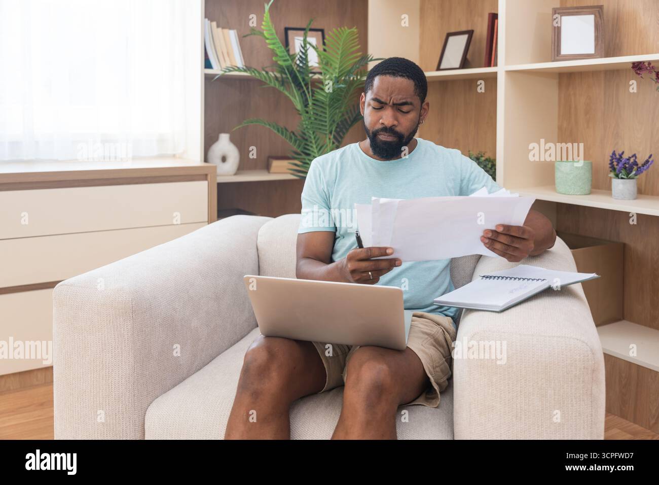Young university student, freelancer business man, working at home on laptop computer, testing new innovative technology and online internet tools whi Stock Photo