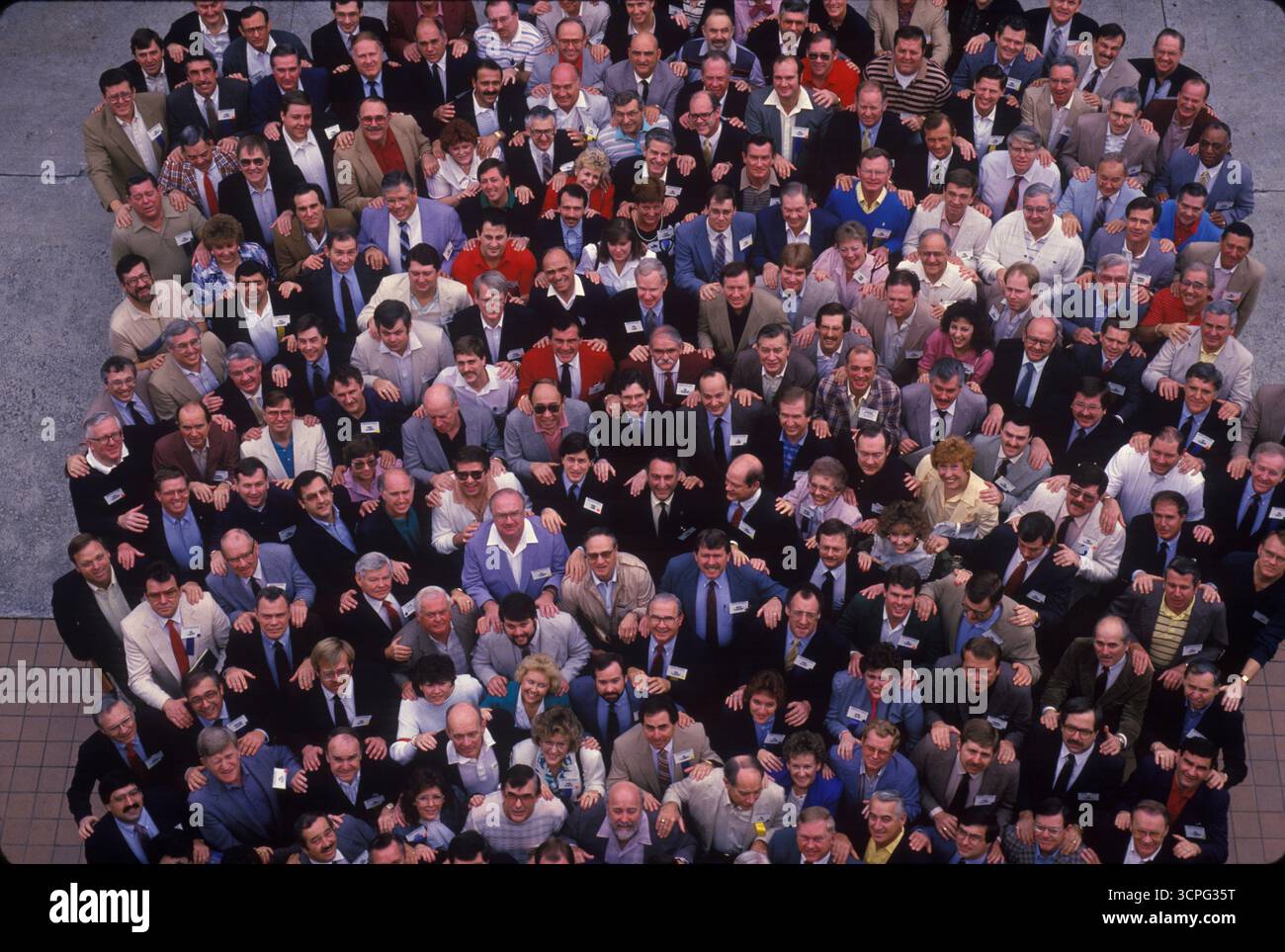 The managers of various branches of a large financial company pose for a portrait, taken from directly above them. Stock Photo