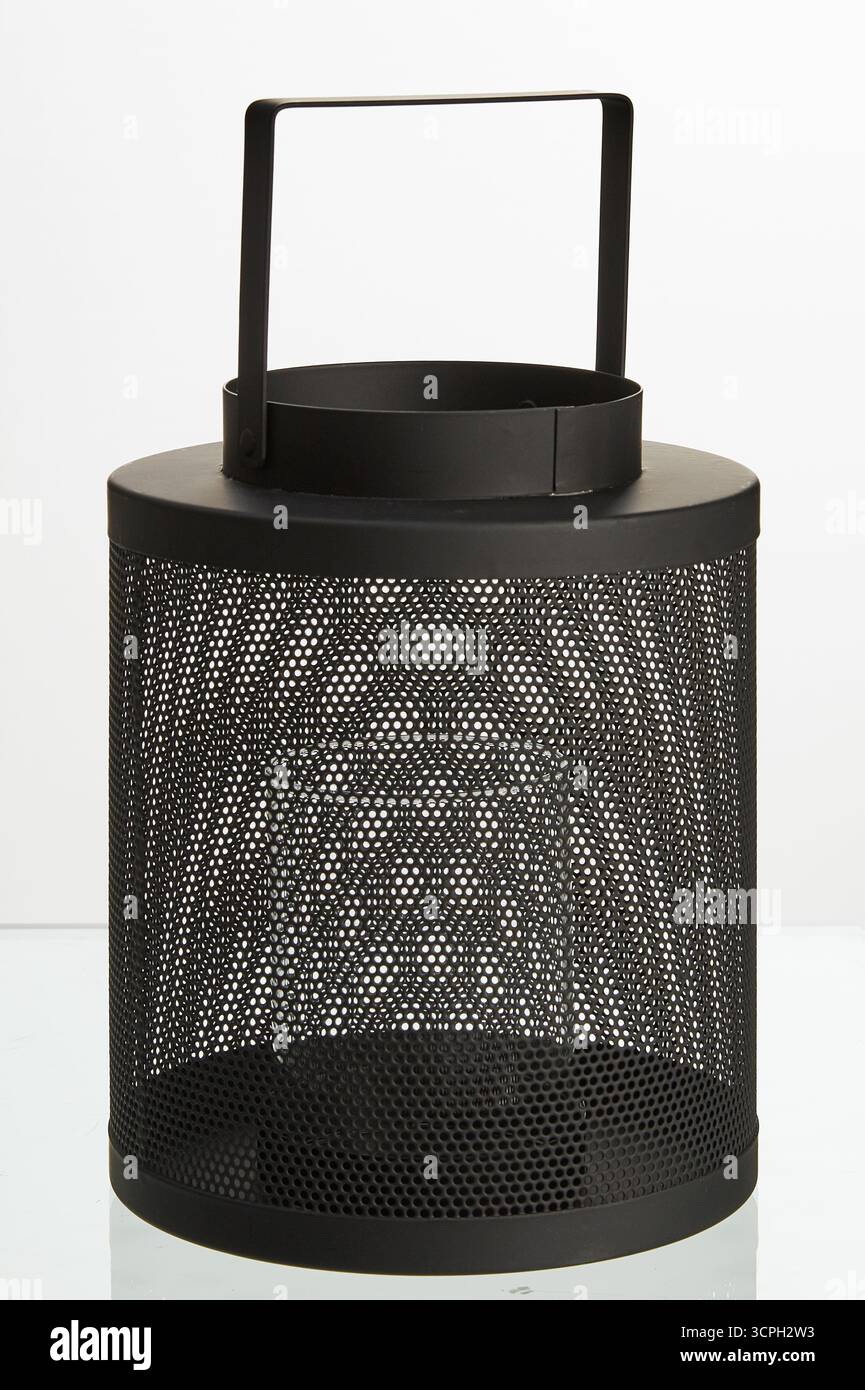 Tall circular black iron mesh lamp with hanging handle isolated nature background with clipping path Stock Photo