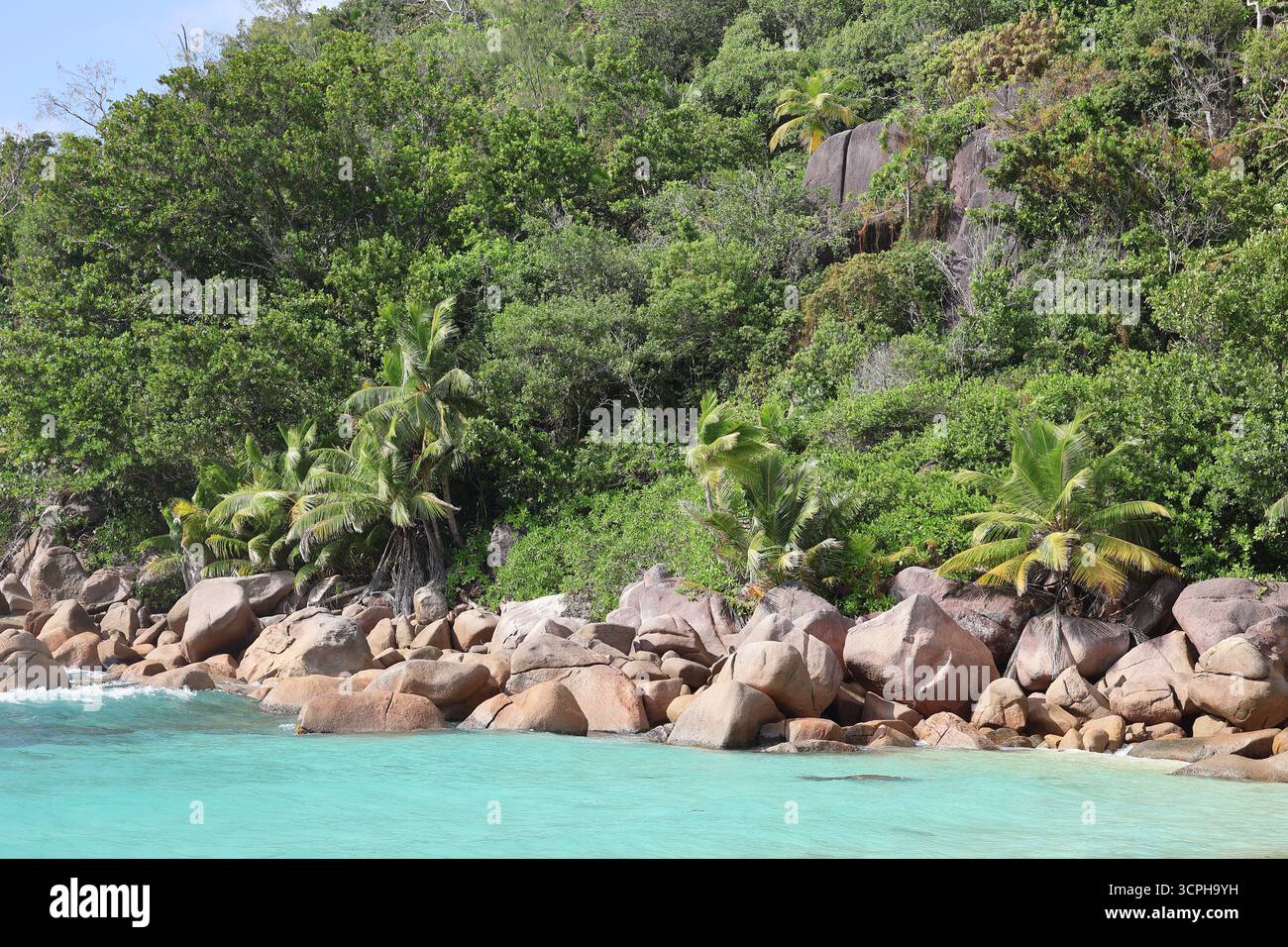 Beautiful beach of Petite Anse Kerlan with turquoise water, Praslin, Seychelles Stock Photo