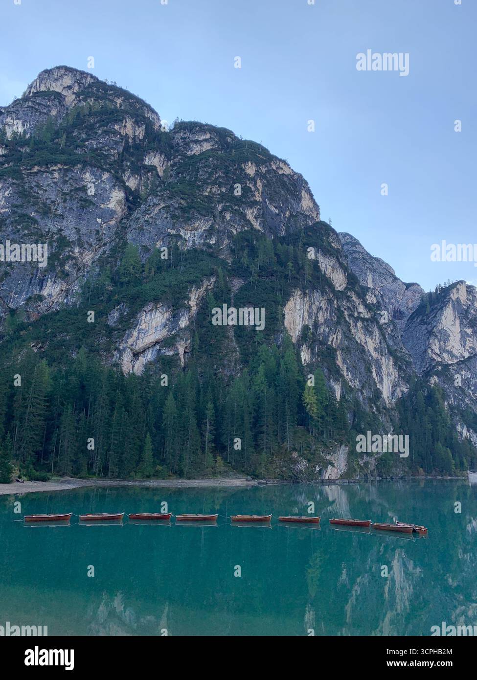 Wooden boats floating on the Lake Braies. The Pragser Wildsee, or Lake Prags or Lake Braies in Dolomites in autumn, South Tyrol, Italy. - Smartphone Captured Stock Image